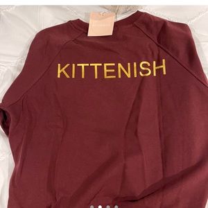 Maroon kittenish jumpsuit with gold lettering